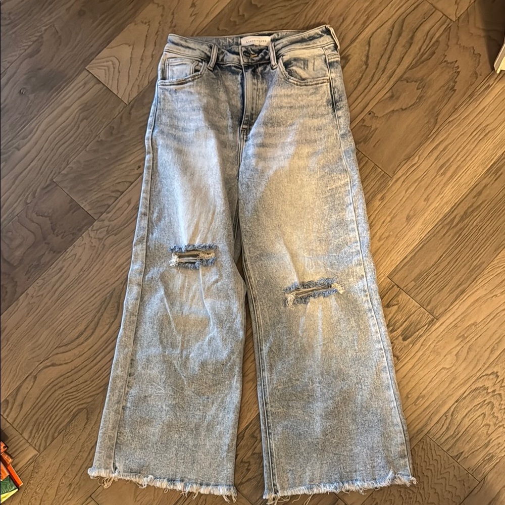 Light Blue Wide Leg Flare Jeans with Distressed Details and Raw Hem